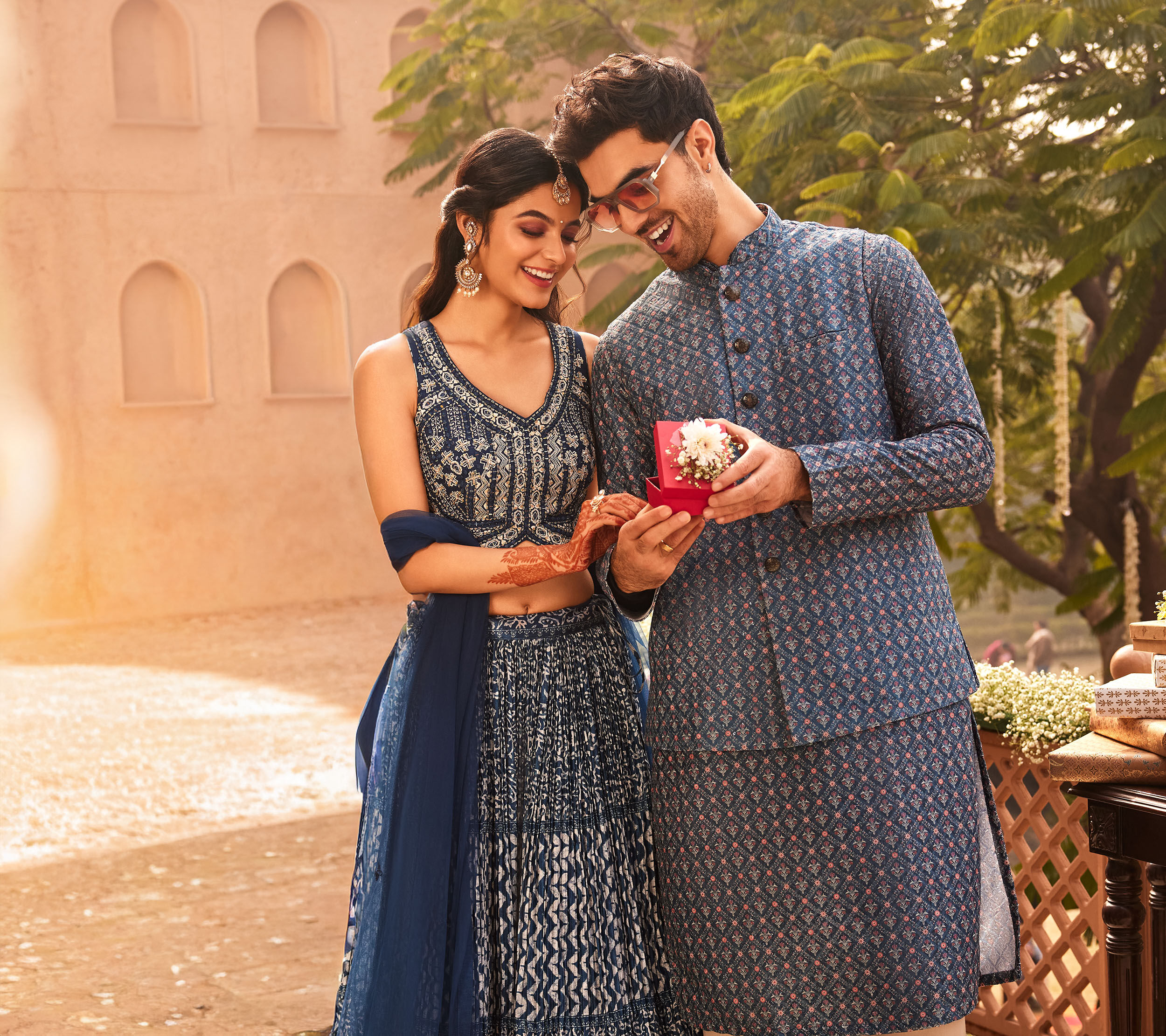 Couple dressed in blue ethnic wear enjoying a royal palace destination wedding celebration
